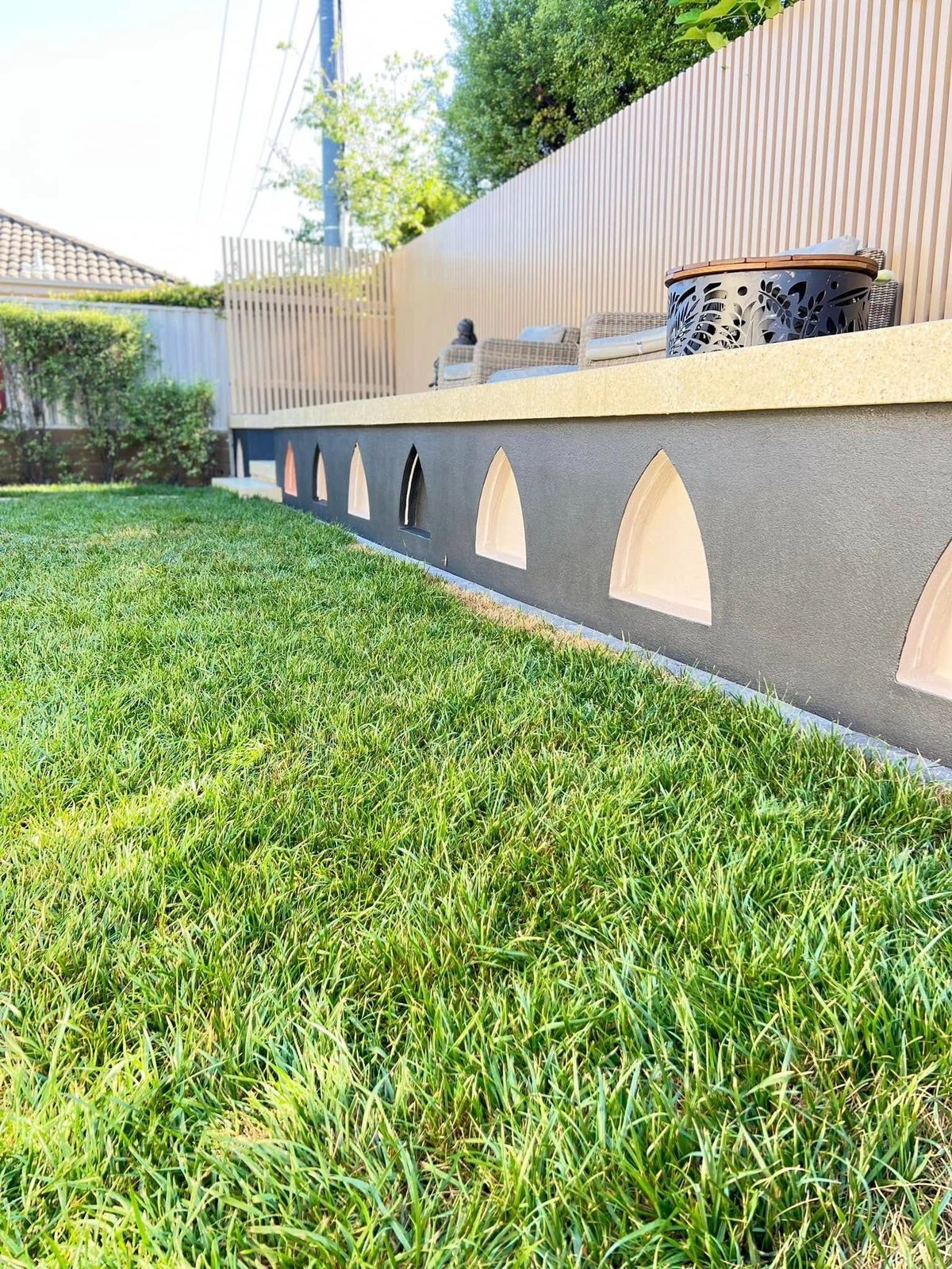 Bagged and rendered brick wall with arched openings