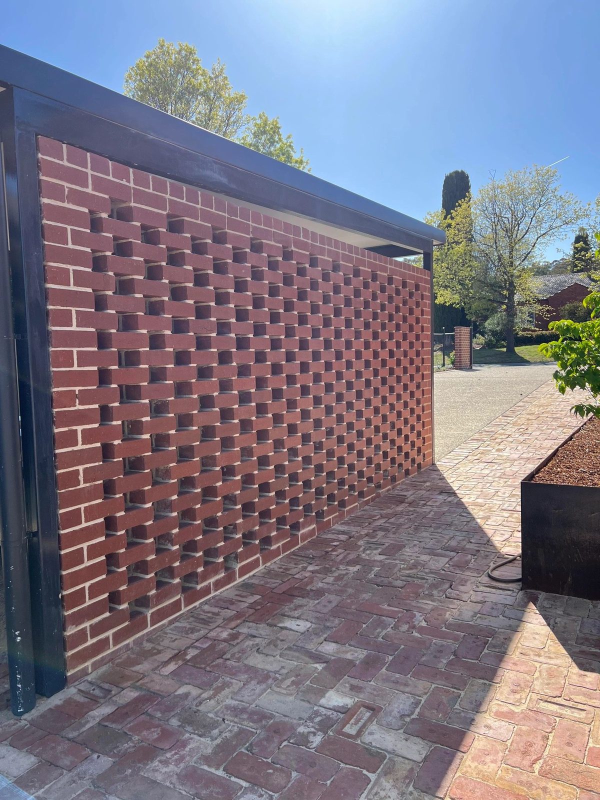 Brick paved driveway with feature brick wall