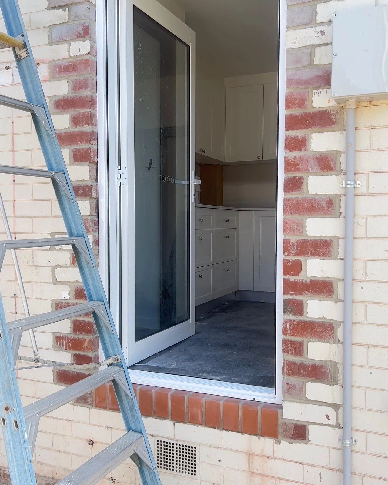 Brick repair scope in progress around a doorway opening