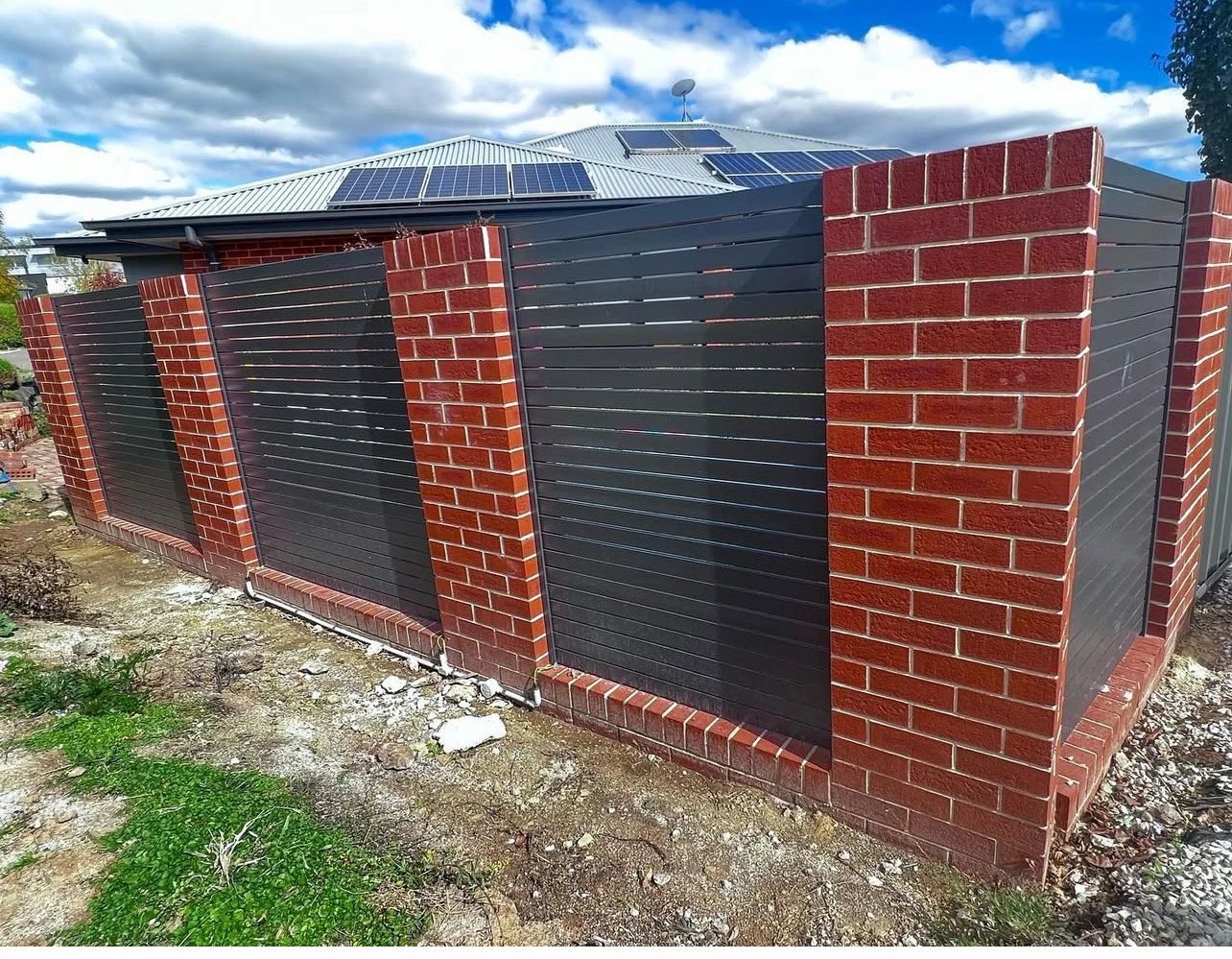 Brick fence piers with metal infill panels in Canberra